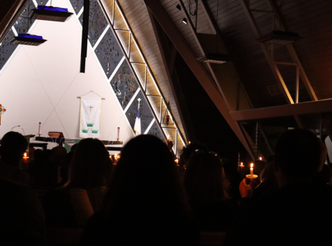 Attendees hold candles at a vigil in Kenosha for people who have died at the hands of ICE. 