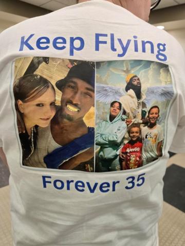 Alyssa Sura, the mother of 3 of the victim's 6 children, displays a tee shirt with an old photo of herself with the victim. 