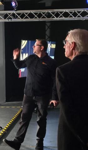 Gov. Evers gets an explanation from Backyard Dream Production owner Alex Kudrna. 