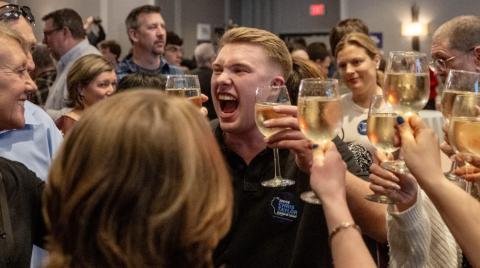 Mitchell Stough, president of the Carthage College Democrats, celebrates with other attendees at the Judge Chris Taylor election party Tuesday, April 7, 2026, at the Madison Concourse Hotel in Madison, Wis. Angela Major/WPR.