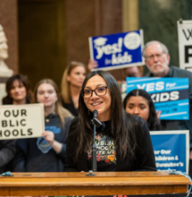Photo of St. Rep. Angelina Cruz speaking at a rally. 