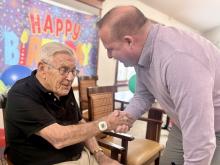 Mayor Dave Bogdala hands a proclamation to Ed Maurer. 
