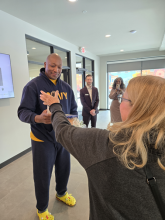 Mayor Bogdala's mother, Linda, presents Nicholas Beard with a basket. 