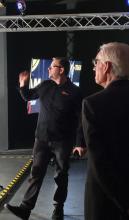 Gov. Evers gets an explanation from Backyard Dream Production owner Alex Kudrna. 