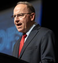 Tom Tiffany speaking at a podium. 