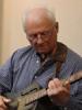 Kerry Spitzer playing guitar in the studio